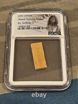 John lennon wood piece from personal keyboard from sothebys cag slab the beatles